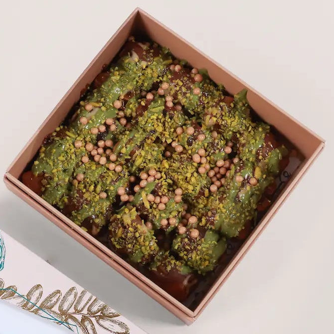 Taghmisa Sukkari Pistachio dates in a gift box with Tamra Choco branding